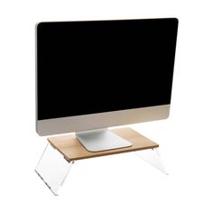 a computer monitor sitting on top of a wooden stand