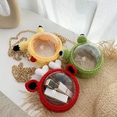 three small objects are sitting on a white surface next to some straw hats and other items