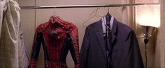 two spider - man suits are hanging on a clothes rack