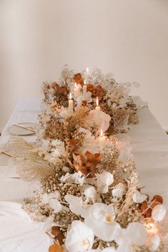 the table is set with candles and flowers