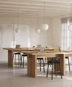 a dining table with chairs and laptops on it