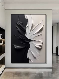 a white and black painting hanging on the wall