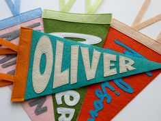 an assortment of different colored pennants with the word oliver printed on one side