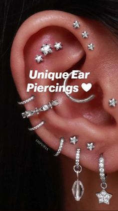 the ear is adorned with silver stars and crescents, as well as dangling earrings