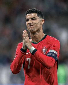 a soccer player is applauding with his hands together