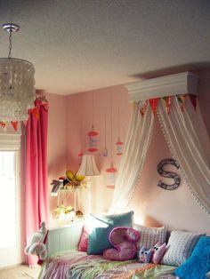 a bedroom with pink walls, curtains and a bed in the corner is decorated with stuffed animals