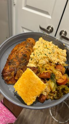 a person holding a plate with some food on it