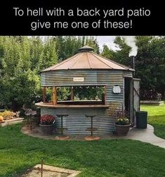 a gazebo sitting on top of a lush green field