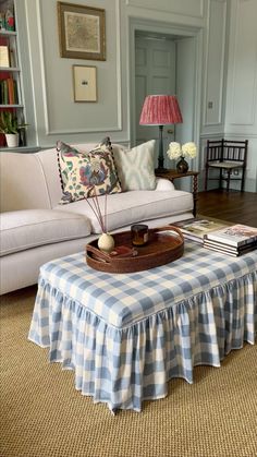 a living room filled with furniture and a checkered table cloth on top of it