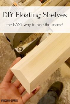 a person holding a piece of wood with text overlay reading diy floating shelves the easy way to hide the seams