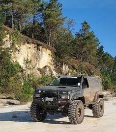 an off road vehicle parked on the side of a dirt road