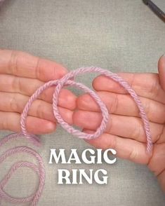 a person holding some pink yarn in their hands with the words magic ring on it