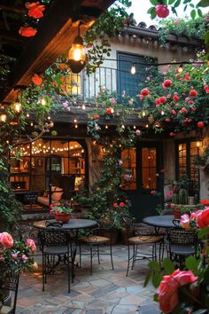 an outdoor patio with tables and chairs covered in flowers