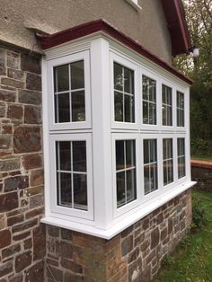 a white window on the side of a brick building