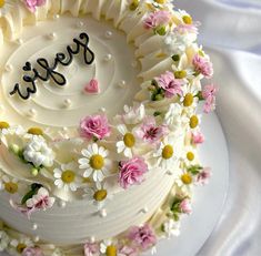 a white cake decorated with flowers and the word fresh on it's frosting