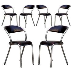 six chairs with black leather seats and chrome legs, all in the same color scheme