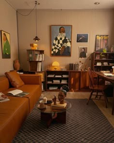 a living room filled with furniture and pictures on the wall