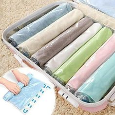 an open suitcase filled with lots of different colored sheets