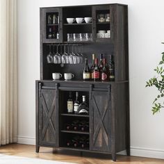 a wooden cabinet with wine glasses and bottles