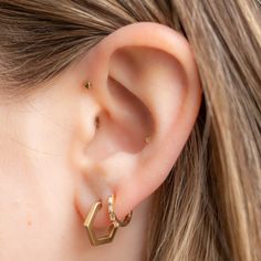 modern + geometric. 14k gold hexagon hoops hug the earlobe perfectly. These gold hexagon hoops are an edgy addition to your ear stack. Earring Specifications: hoop measures 2 x 2mm, 12.5mm in length hexagon hoops have a matte finish available in your choice of 14k rose, white or yellow gold Gold Hex, Ear Stack, Huggie Hoop Earrings, Yellow Gold, Yellow, Gold