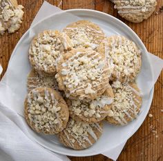 a white plate topped with cookies covered in frosting