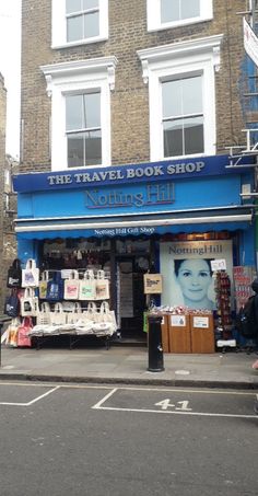 the travel book shop is on the side of the street in front of a building