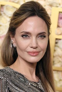 Angelina Jolie debuts a stunning hair transformation! with chic side bangs, adding a modern twist to her timeless style. #hairstyles #hairtransformation #sidebangs #bangs #celebrity