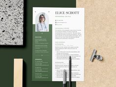 a green and white resume on top of a desk next to a pen, pencil and paper