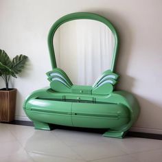 a green mirror sitting on top of a white floor next to a potted plant