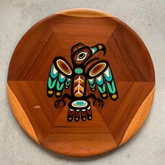 a wooden plate with an image of a bird on it