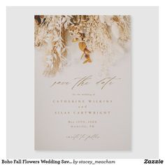 an elegant wedding card with gold foil flowers and greenery on the front, in white