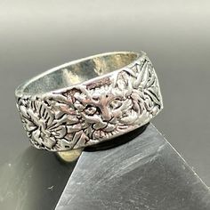 a silver ring sitting on top of a metal object