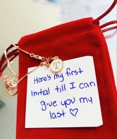 a red velvet bag with a card attached to it that says here's my first initial till i can give you my last love