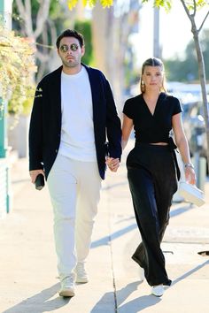 a man and woman walking down the street