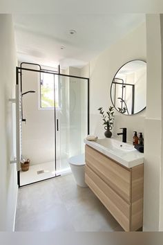 a bathroom with a sink, mirror and shower