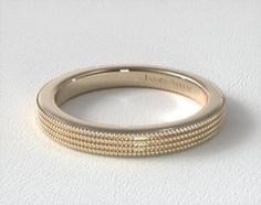 a gold wedding band with beaded edges