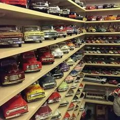 a room filled with lots of toy cars and shelves full of model cars on top of them