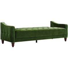 a green couch sitting on top of a white floor next to a wooden frame and legs