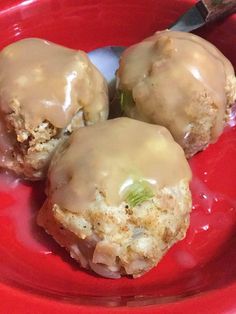 three doughnuts with icing on a red plate