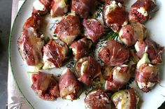 a white plate topped with meat and veggies on top of a wooden table