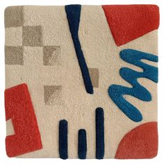 an abstract rug with blue, red and grey shapes on it's surface is shown