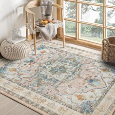 a large rug with an ornate design on the floor next to a chair and table