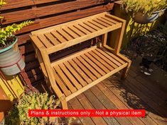 a wooden bench sitting next to a potted plant on top of a wooden deck