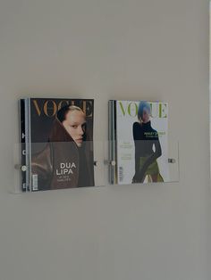 there are two magazines on the wall next to each other, one has a magazine holder