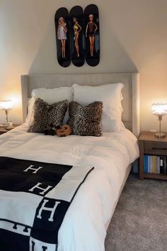 a bedroom with two mirrors above the bed