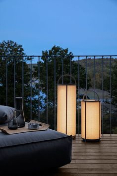 two lamps sitting on top of a wooden table