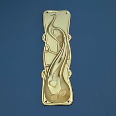 a gold brooch with an image of a woman holding a tennis racquet