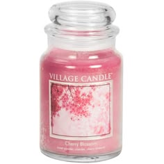 a pink candle that is in a glass jar