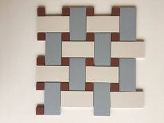 a white, brown and blue tile pattern on the wall