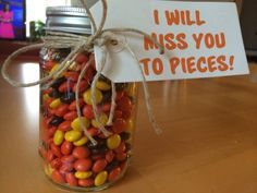 a jar filled with candy and a sign that says i will miss you to pieces